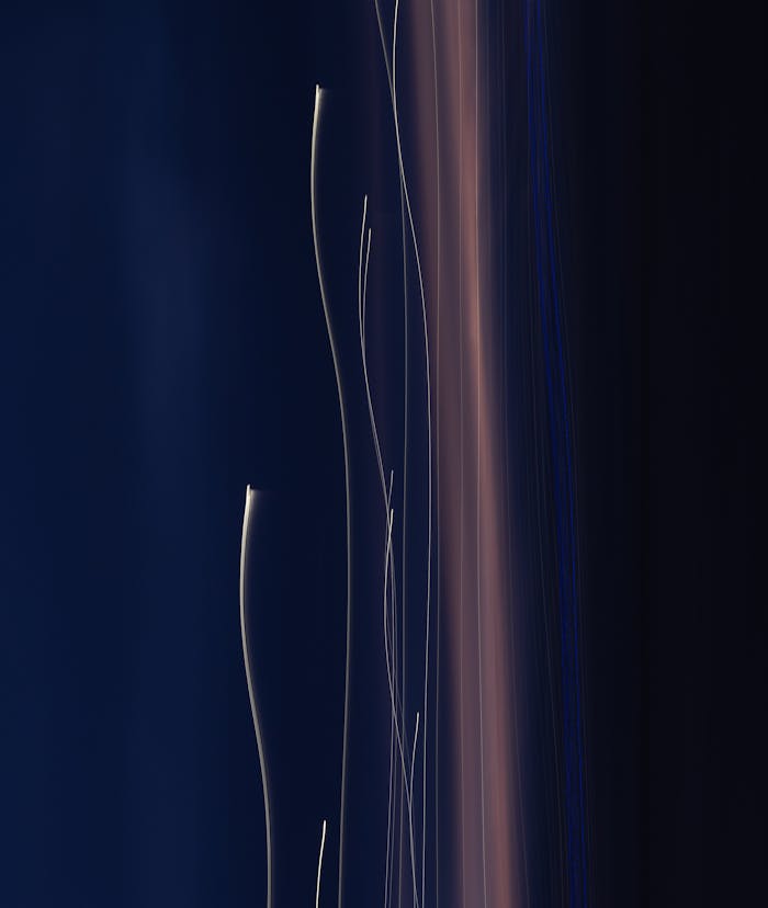 Captivating abstract light trails against a dark background, embodying modern art.